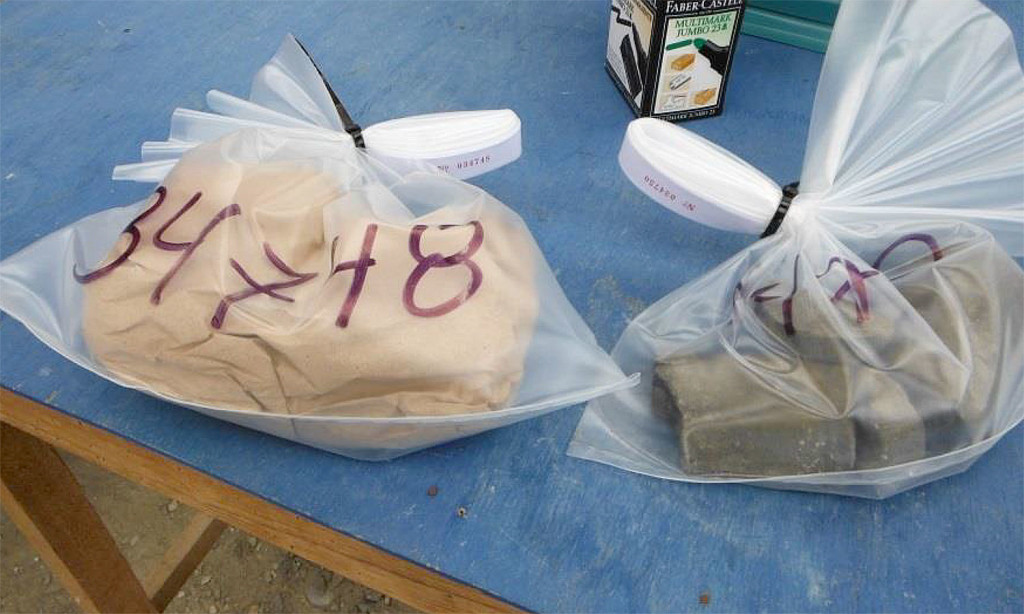 Wrapping Phosphorite Sample in Brown Paper to Prevent Sticking in Sample Bag